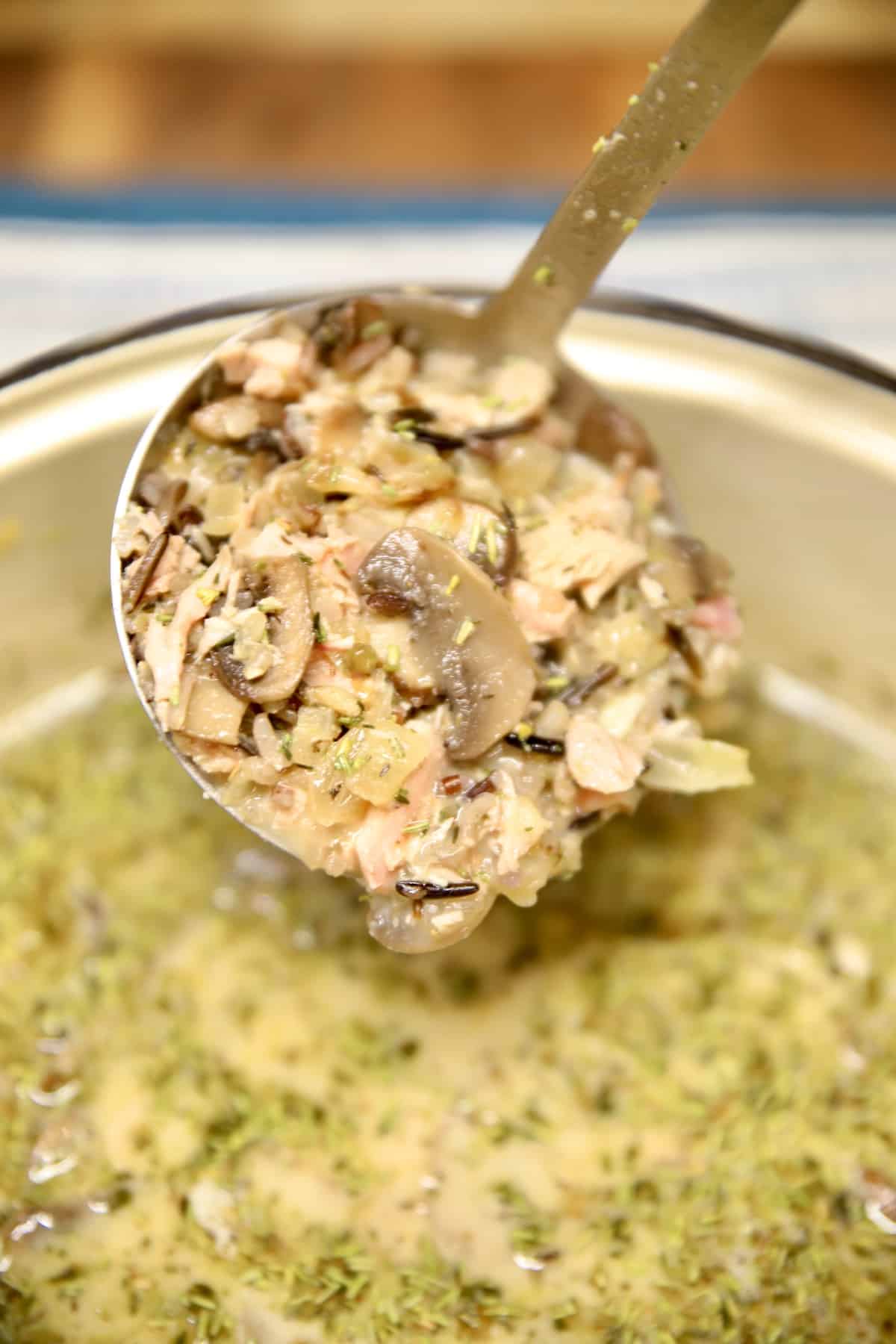 Ladle of creamy chicken wild rice soup. 