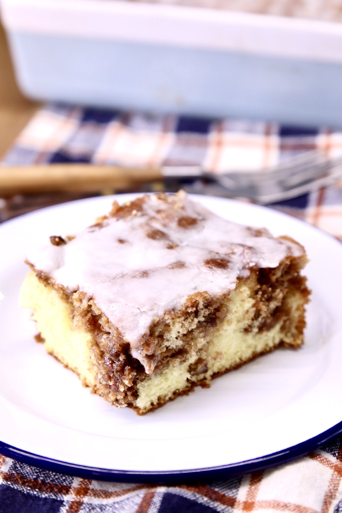 Slice of cinnamon coffee cake with powdered sugar icing