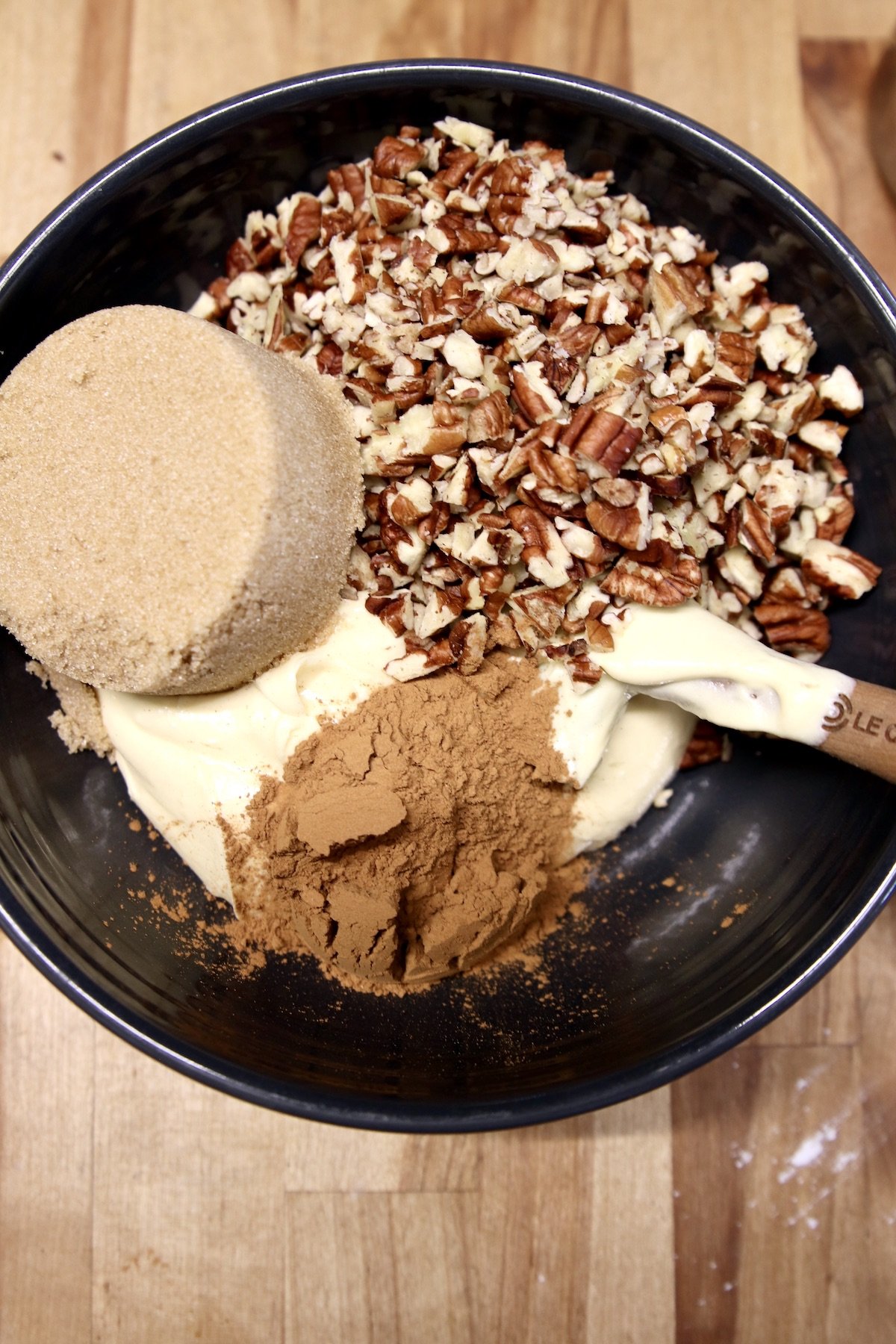 bowl with cake batter, brown sugar, chopped pecans and cinnamon