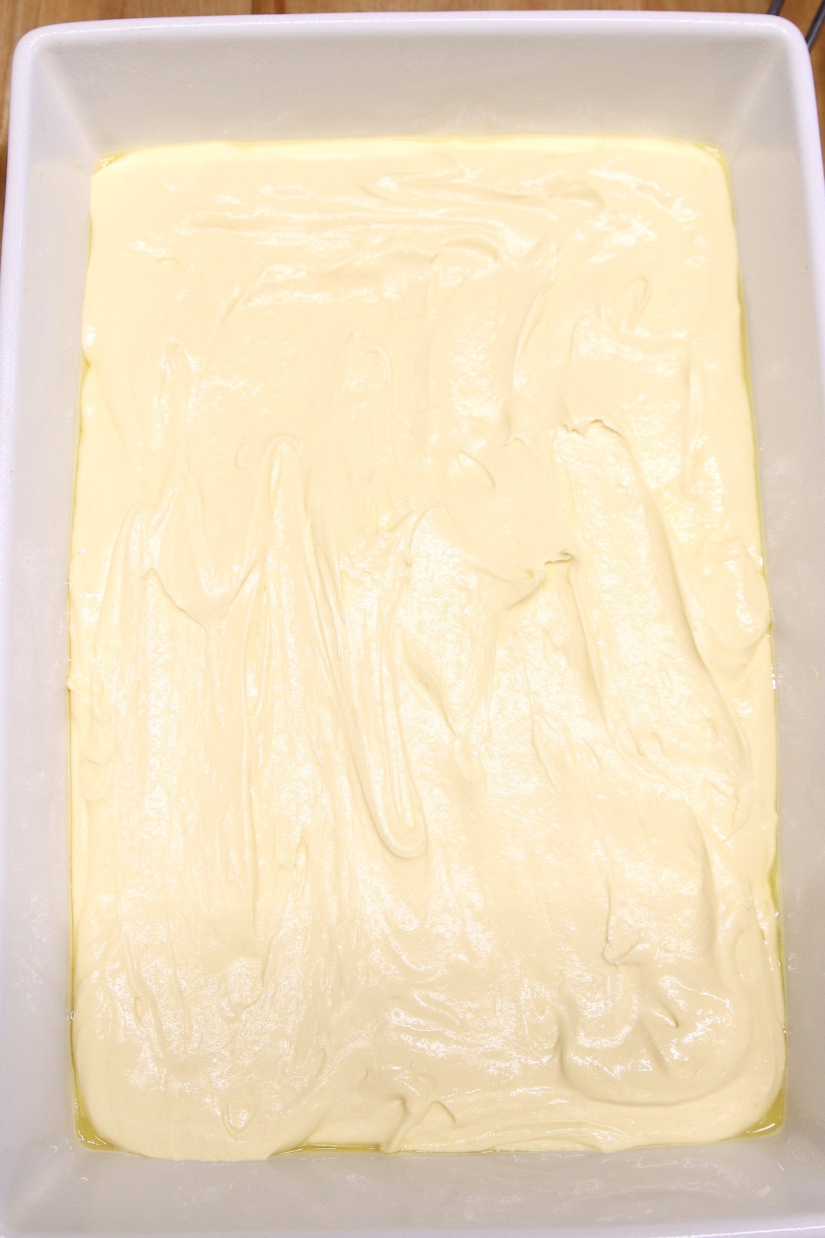 cake batter in a white 9 x 13 cake pan