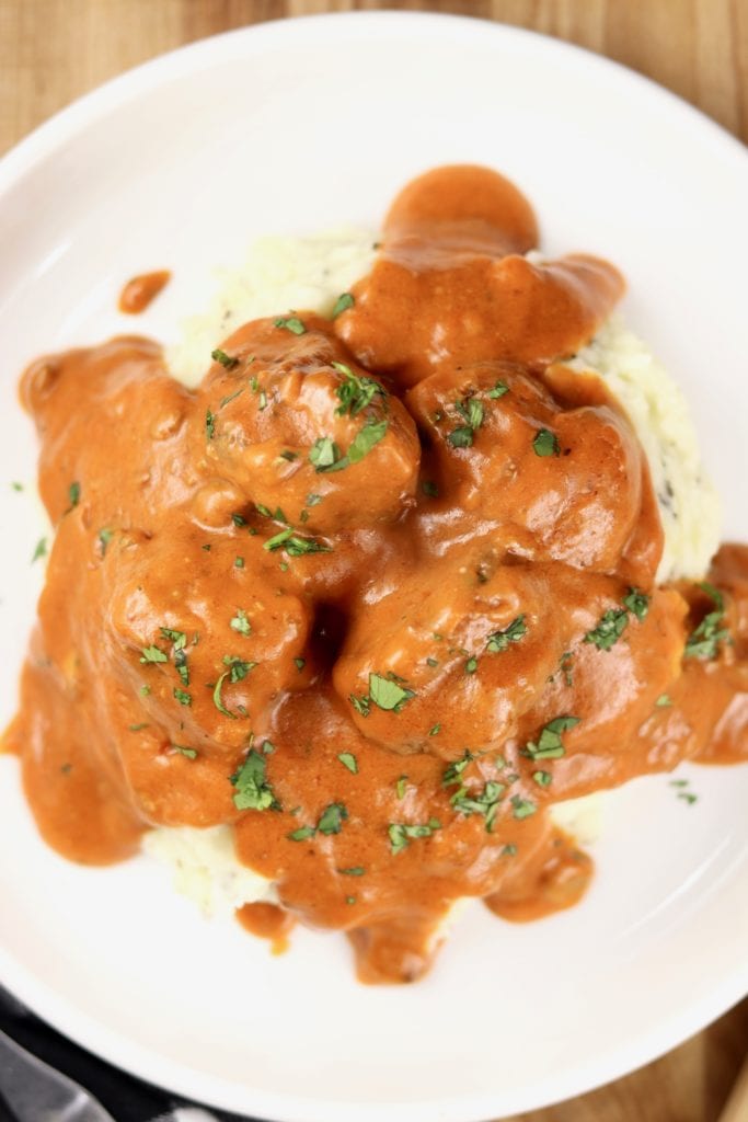 Tomato and mushroom meatballs over mashed potatoes