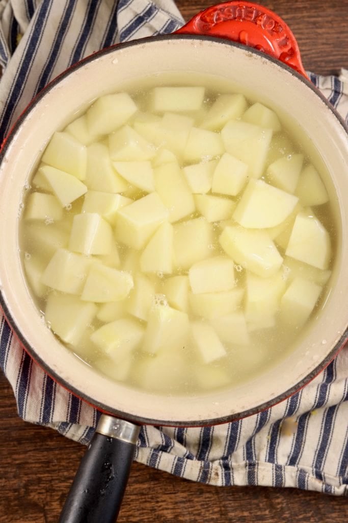 Pan of potato cut into chunks, covered with water