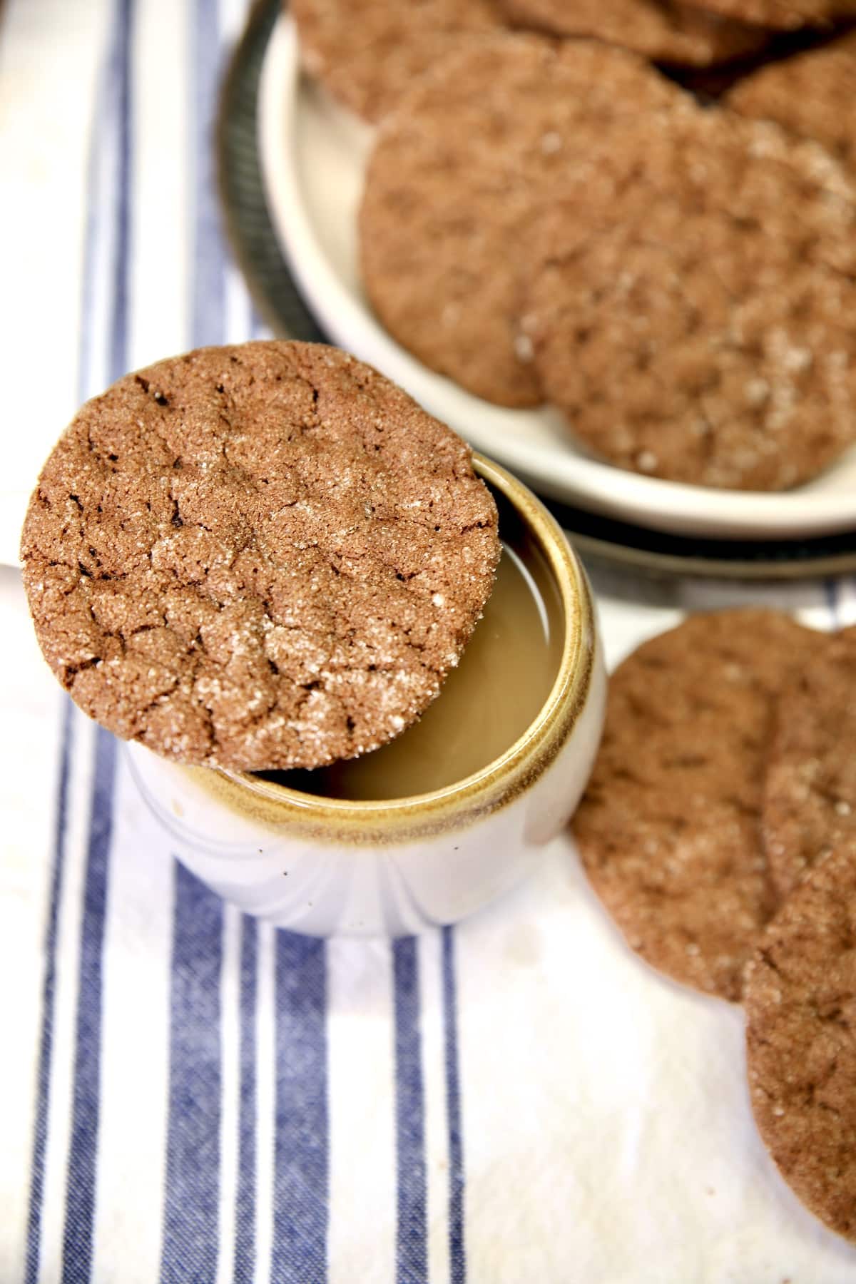 Chocolate cookie on top of cup of coffee.