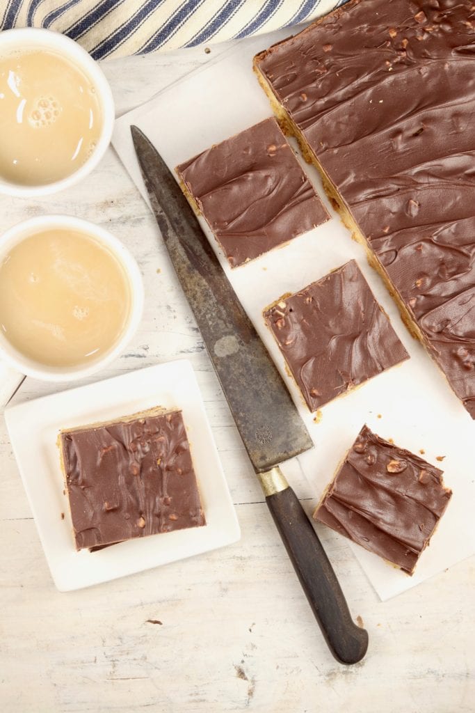 2 cups of coffee with creamer, chocolate dessert bar slices