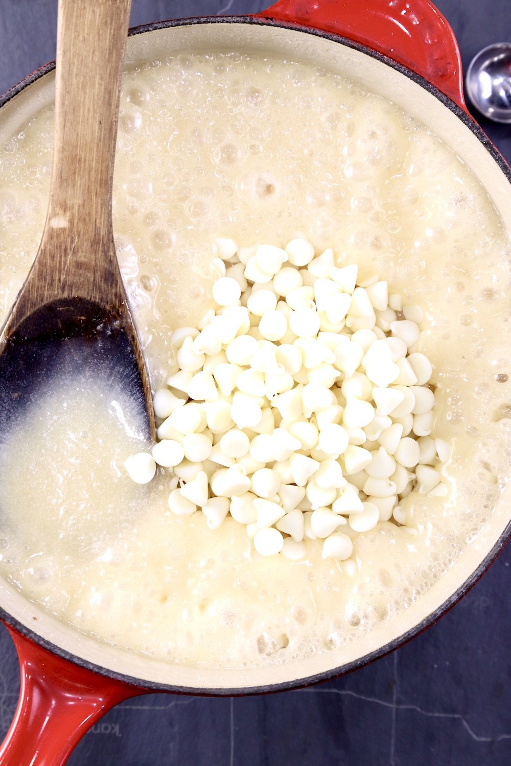 pan of hot fudge mixture with white chocolate chips