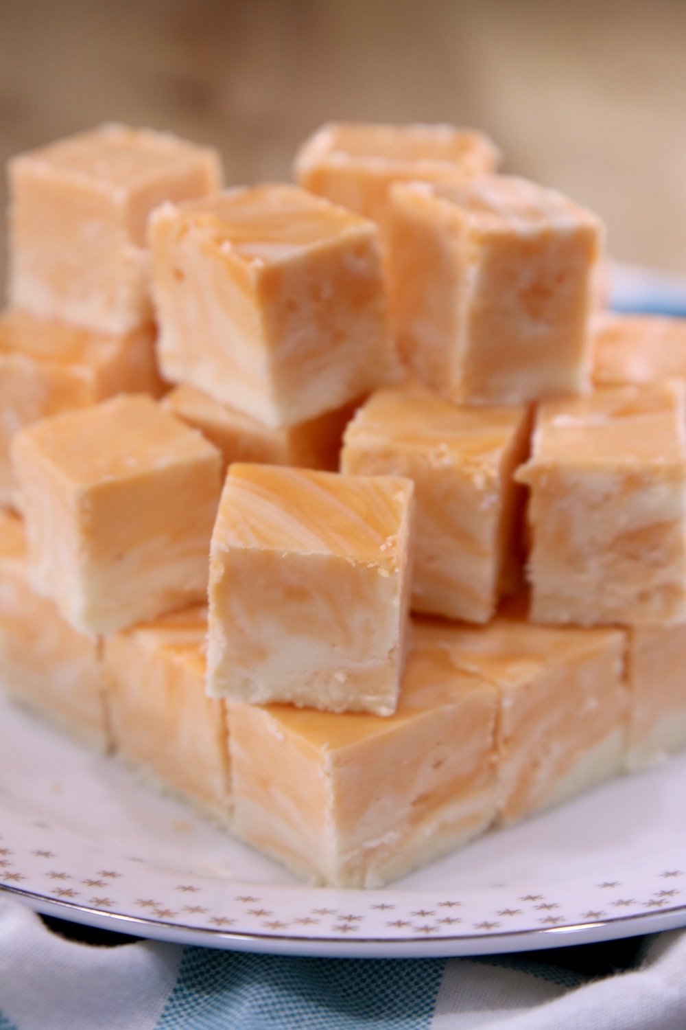 stack of orange cream marble fudge on a white plate