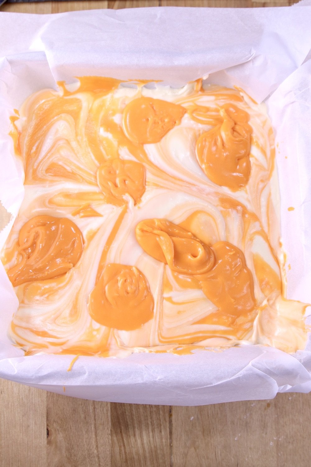 Dollops of orange fudge or marbled fudge in a lined pan