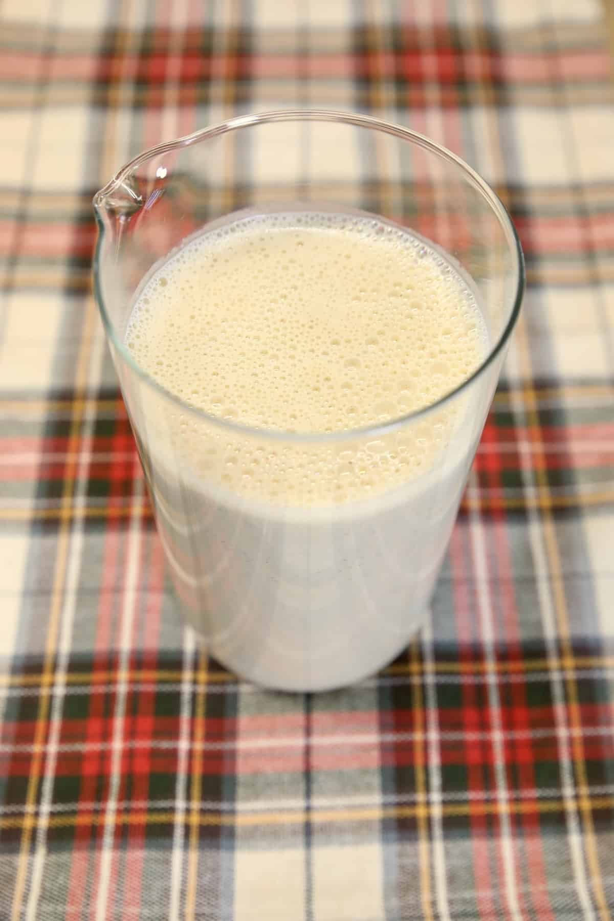 Eggnog in a glass pitcher.
