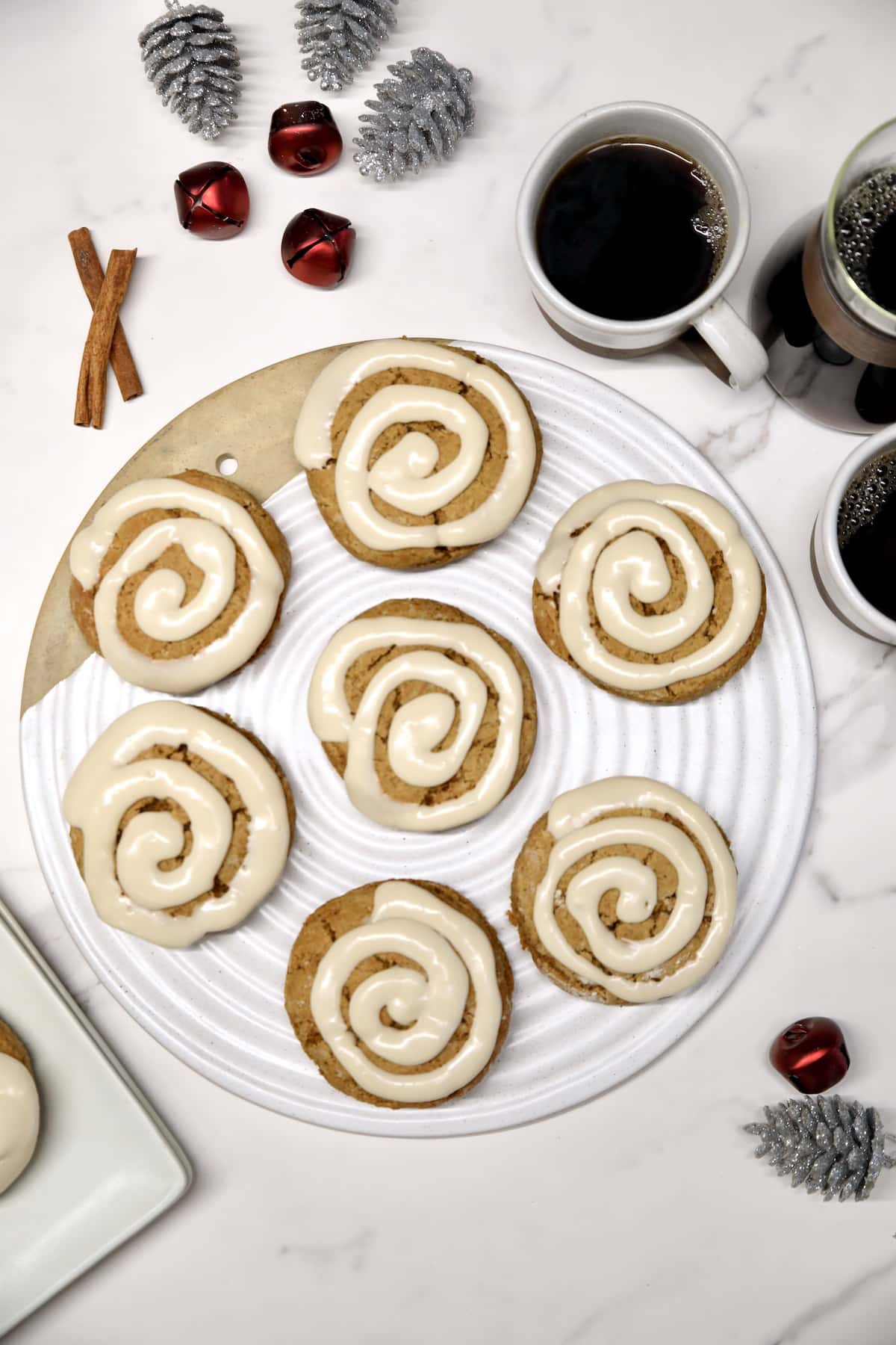 Gingerbread scones with cream cheese icing on a platter.