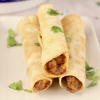 3 beef taquitos on a white plate