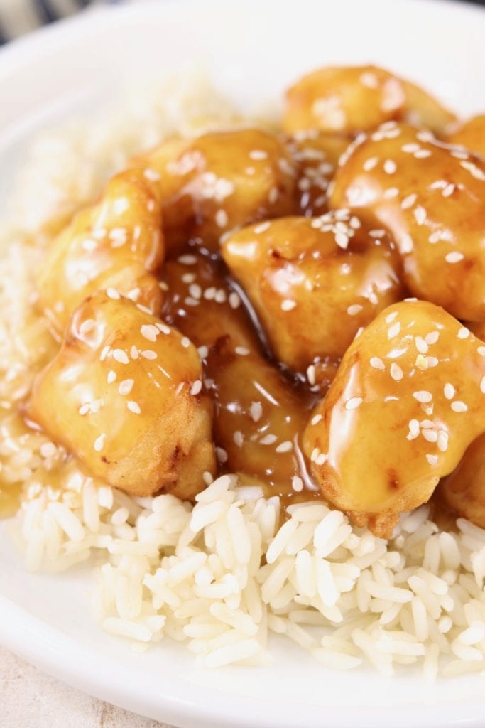 Sesame Chicken and rice in a white bowl