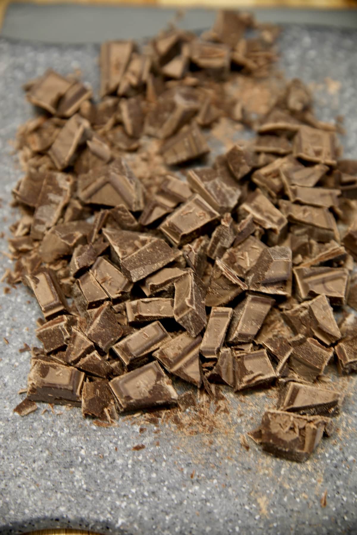 Chopped chocolate on a cutting board.