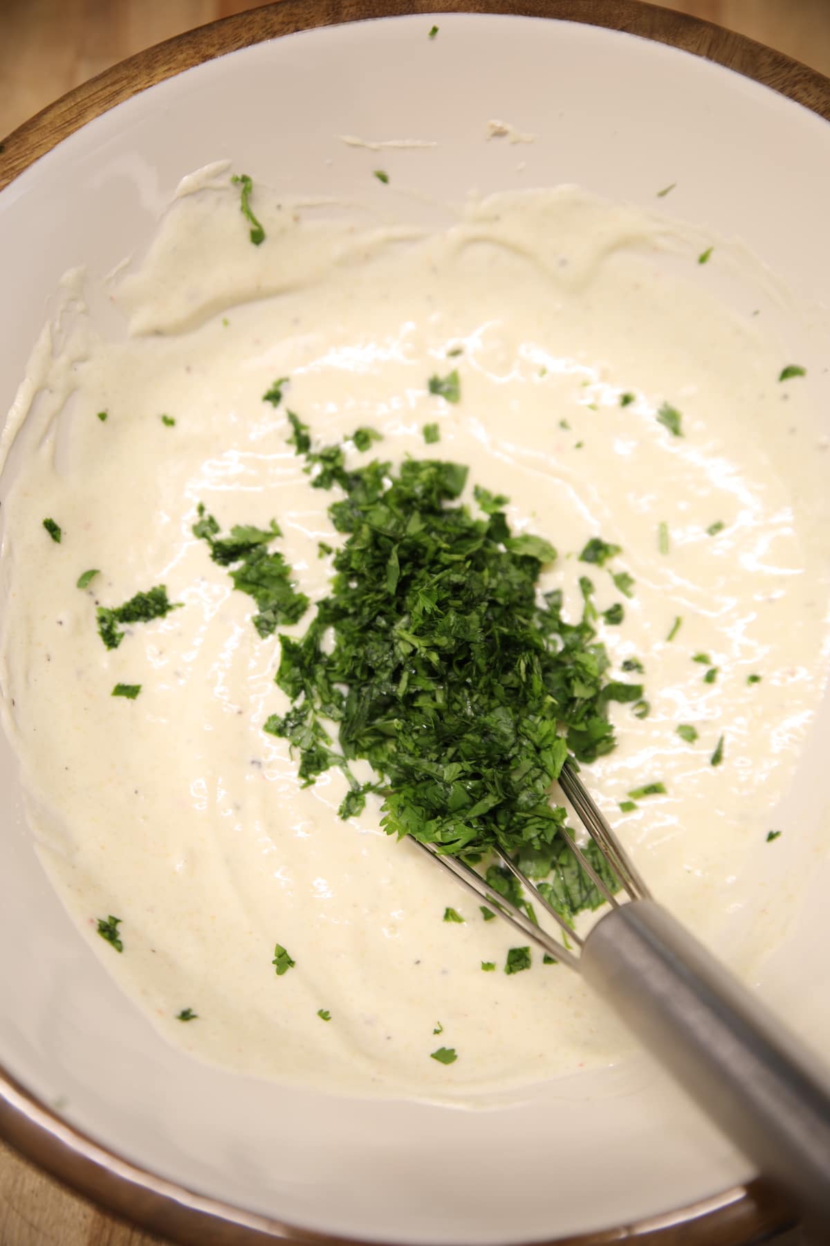 Cilantro in a bowl of slaw dressing.