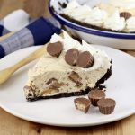 Peanut Butter Pie slice on a plate with Reese's Mini peanut butter cups