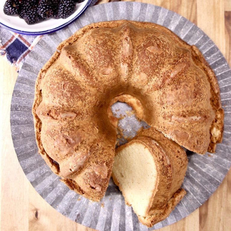 brown butter pound cake on a platter one slice cut