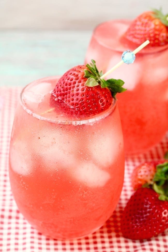 Stemless Wine Glass of Strawberry Wine Punch garnished with a fresh strawberry