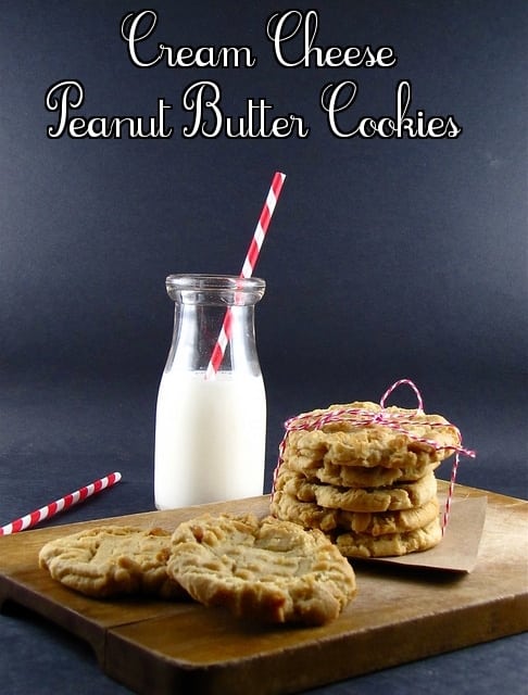 Cookies on board stacked and tied with string with milk and striped straw