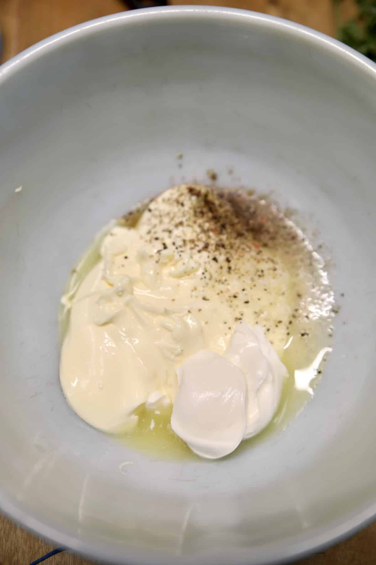Pineapple slaw dressing ingredients in a bowl.