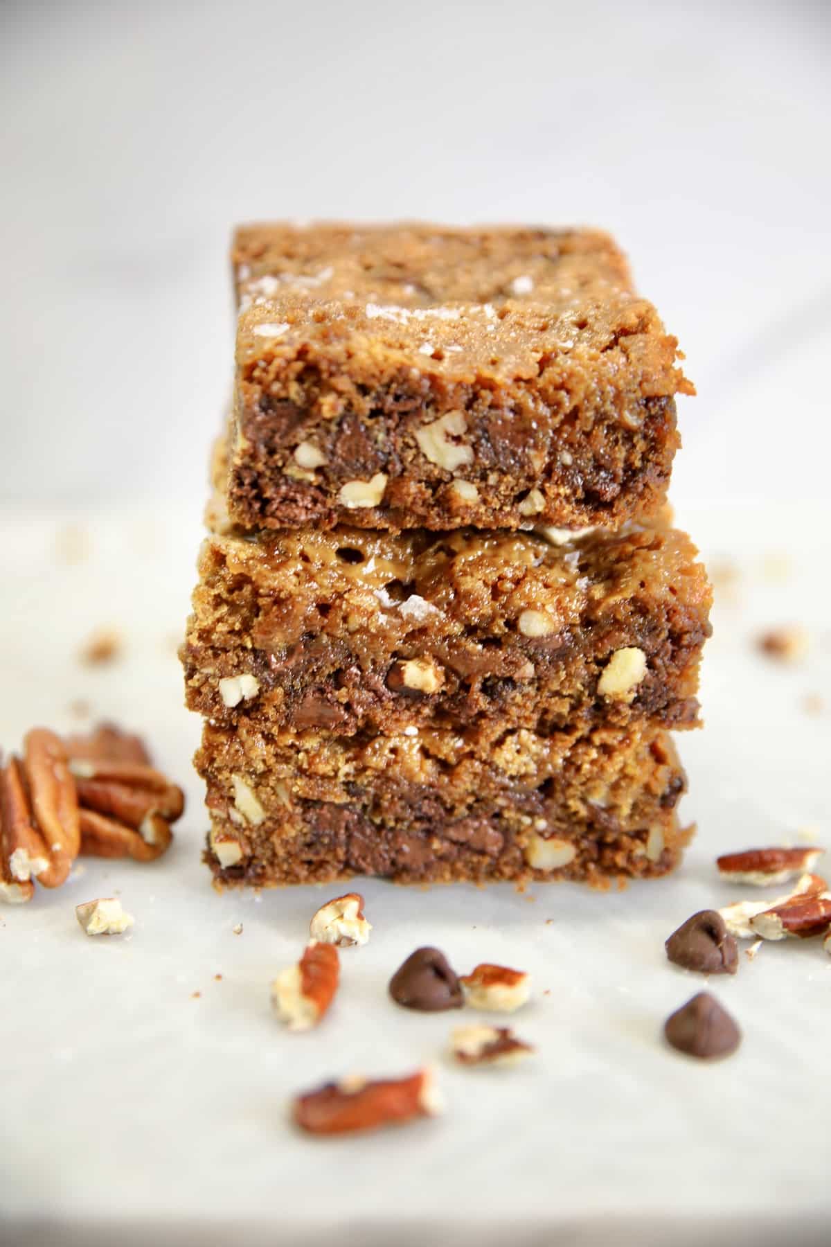 Stack of chocolate chip, caramel, pecan bars.