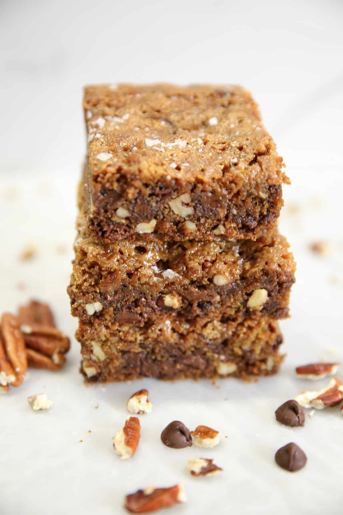 Cookie bars with caramel and chocolate. Chocolate Chip Cookie Bars stacked on a plate.