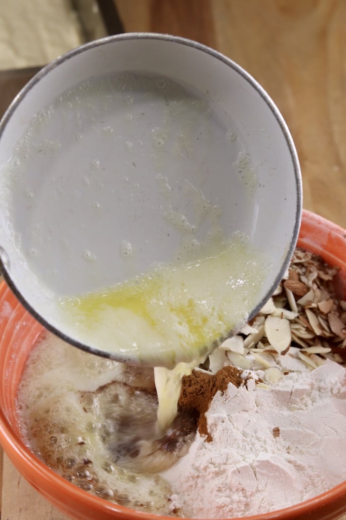 Melted butter pouring into streusel topping