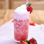 Strawberry Vodka Cocktail in a glass with whipped cream and strawberry