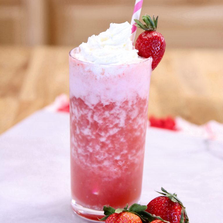 Strawberry Vodka Cocktail in a glass with whipped cream and strawberry