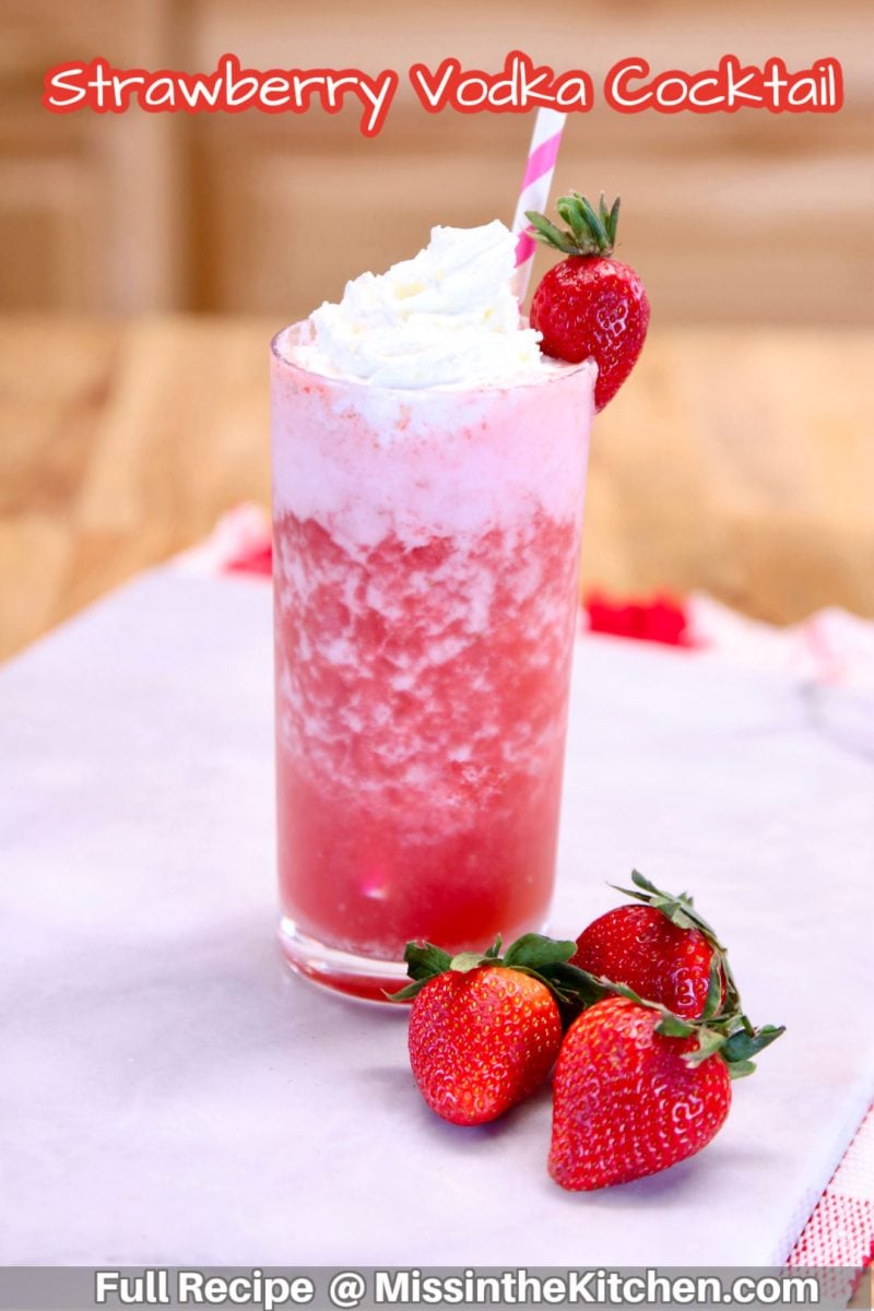 strawberry vodka cocktail with whipped cream and strawberry garnish.