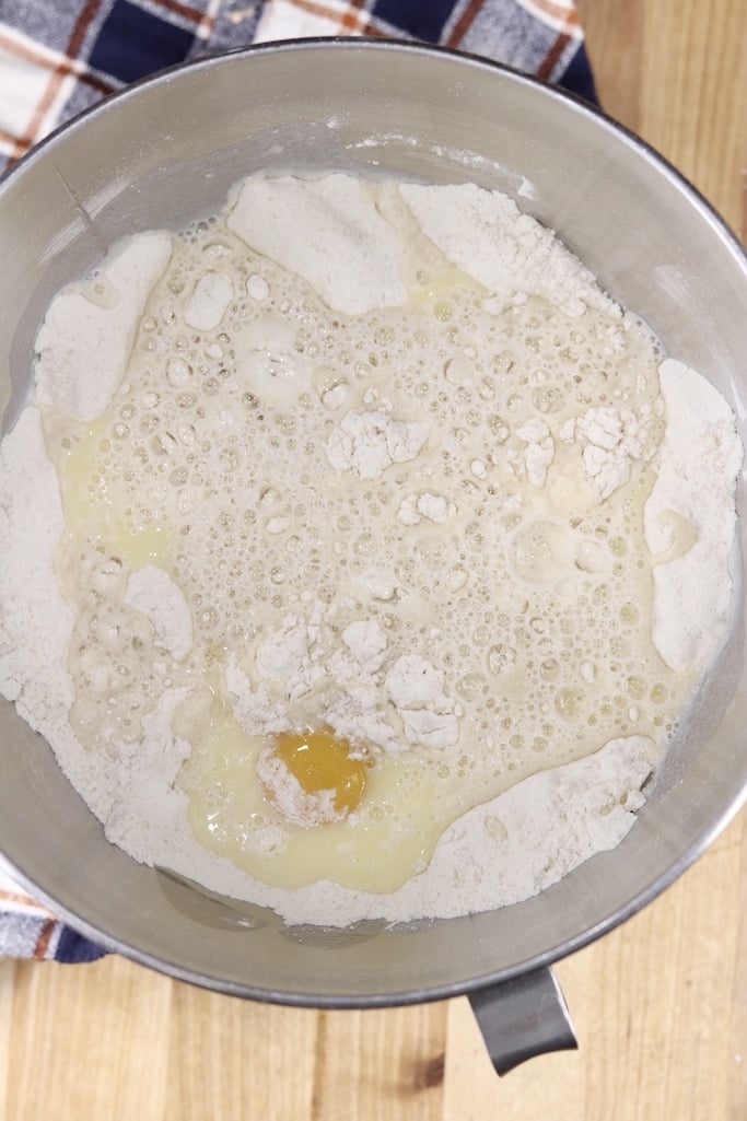Bowl of flour, sugar, yeast, milk, eggs and butter for coffee cake