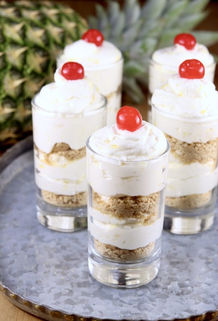 Pineapple Cheesecake Parfaits with cherry garnish
