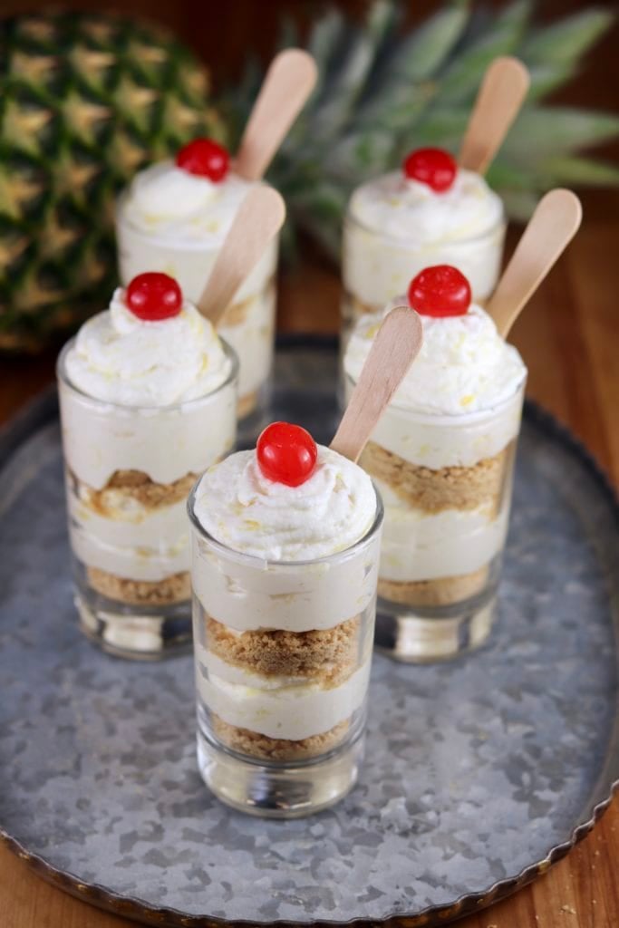 Pineapple Cheesecake Parfait with a fresh pineapple in background
