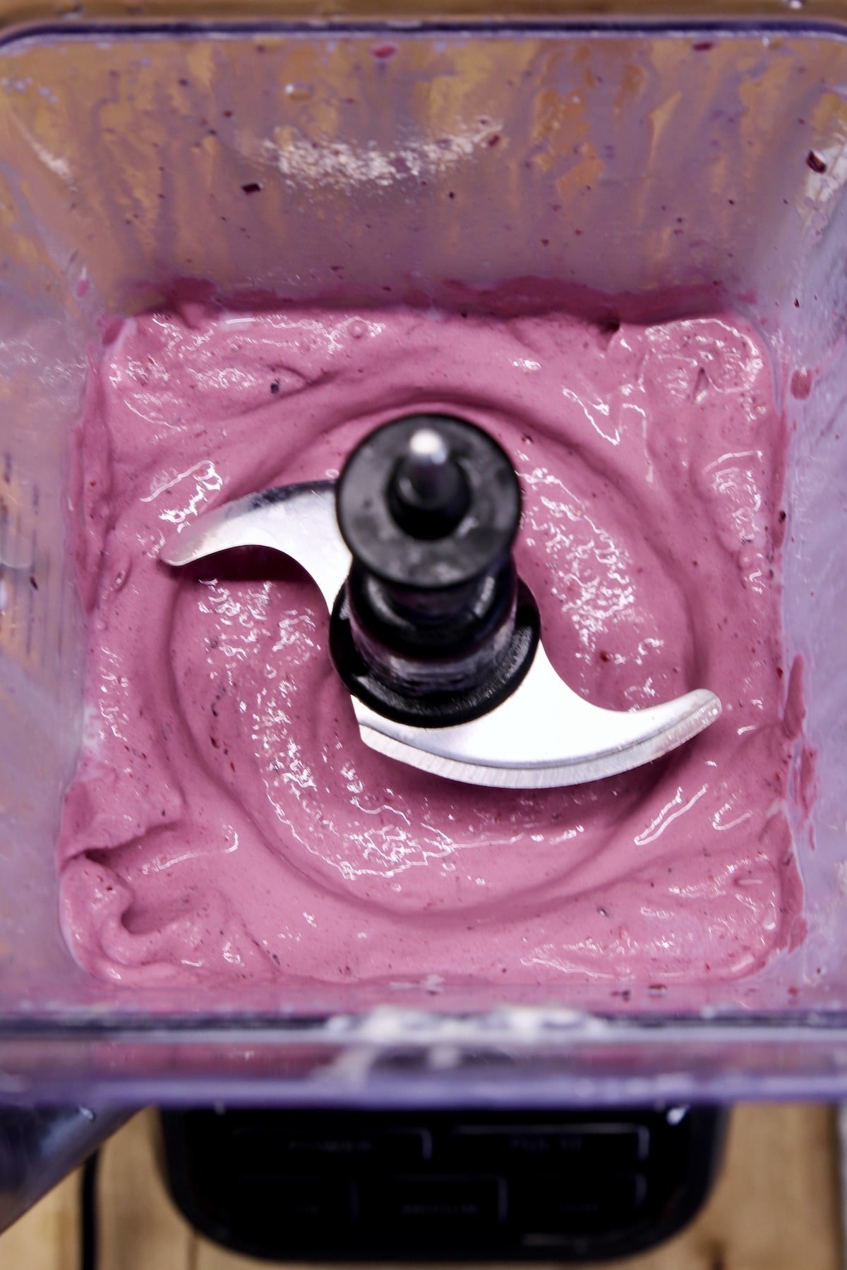 overhead of blender with blackberry milkshake.