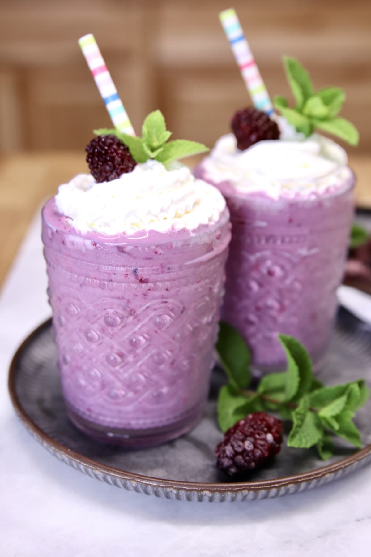 2 glasses with blackberry milkshakes.