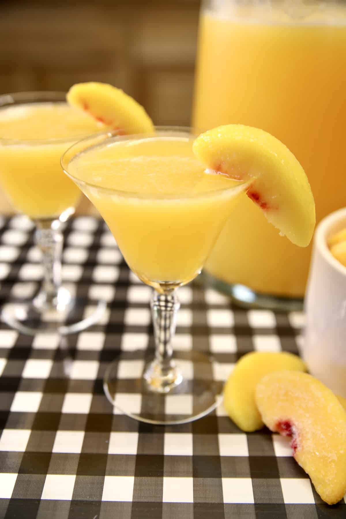 Peach Moscato Punch in 2 glasses, peach slice garnish.
