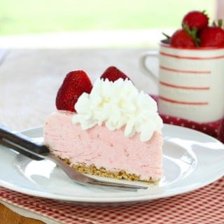 Slice of frozen strawberry cheesecake.