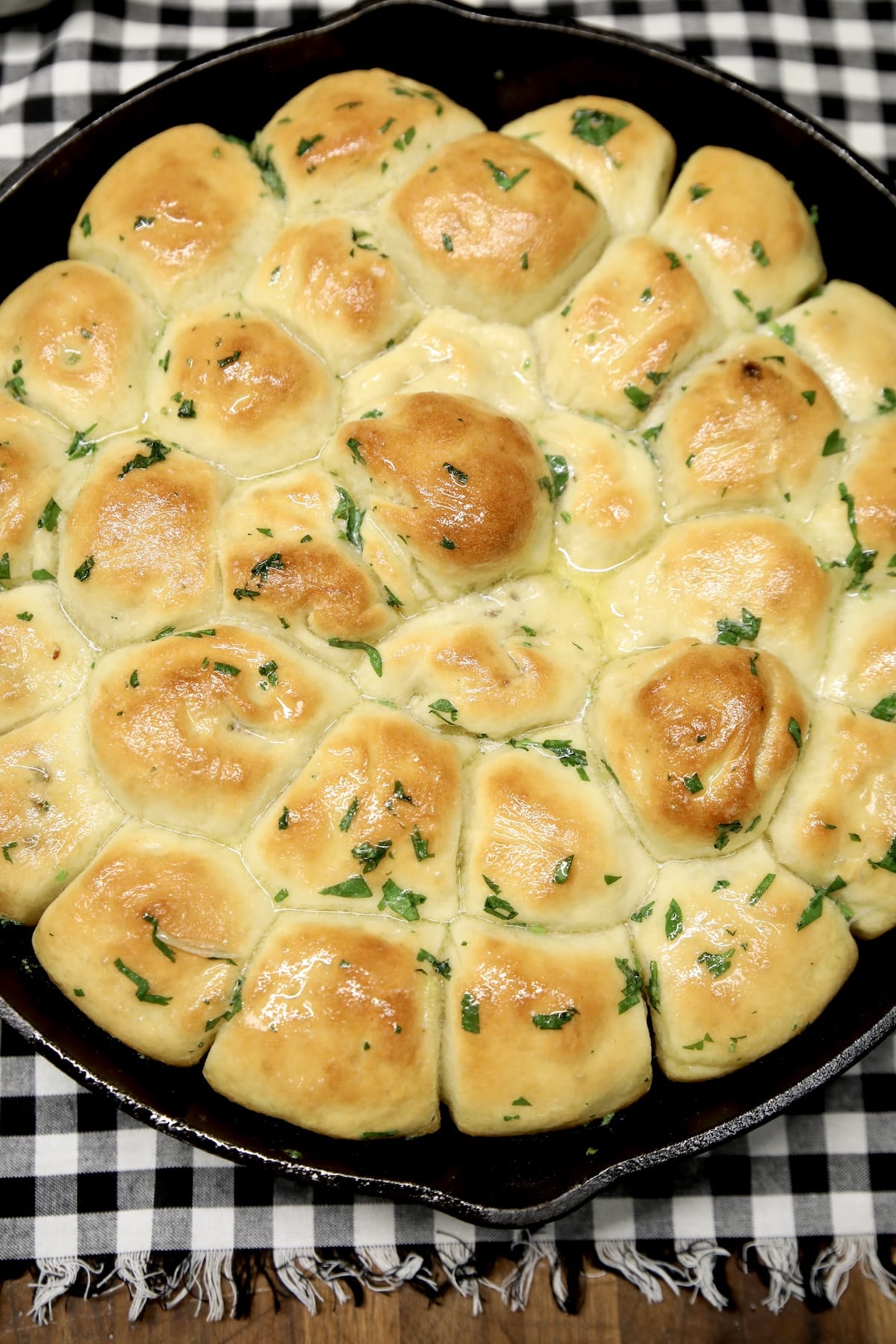 Meatball appetizers wrapped in pizza dough in a skillet.
