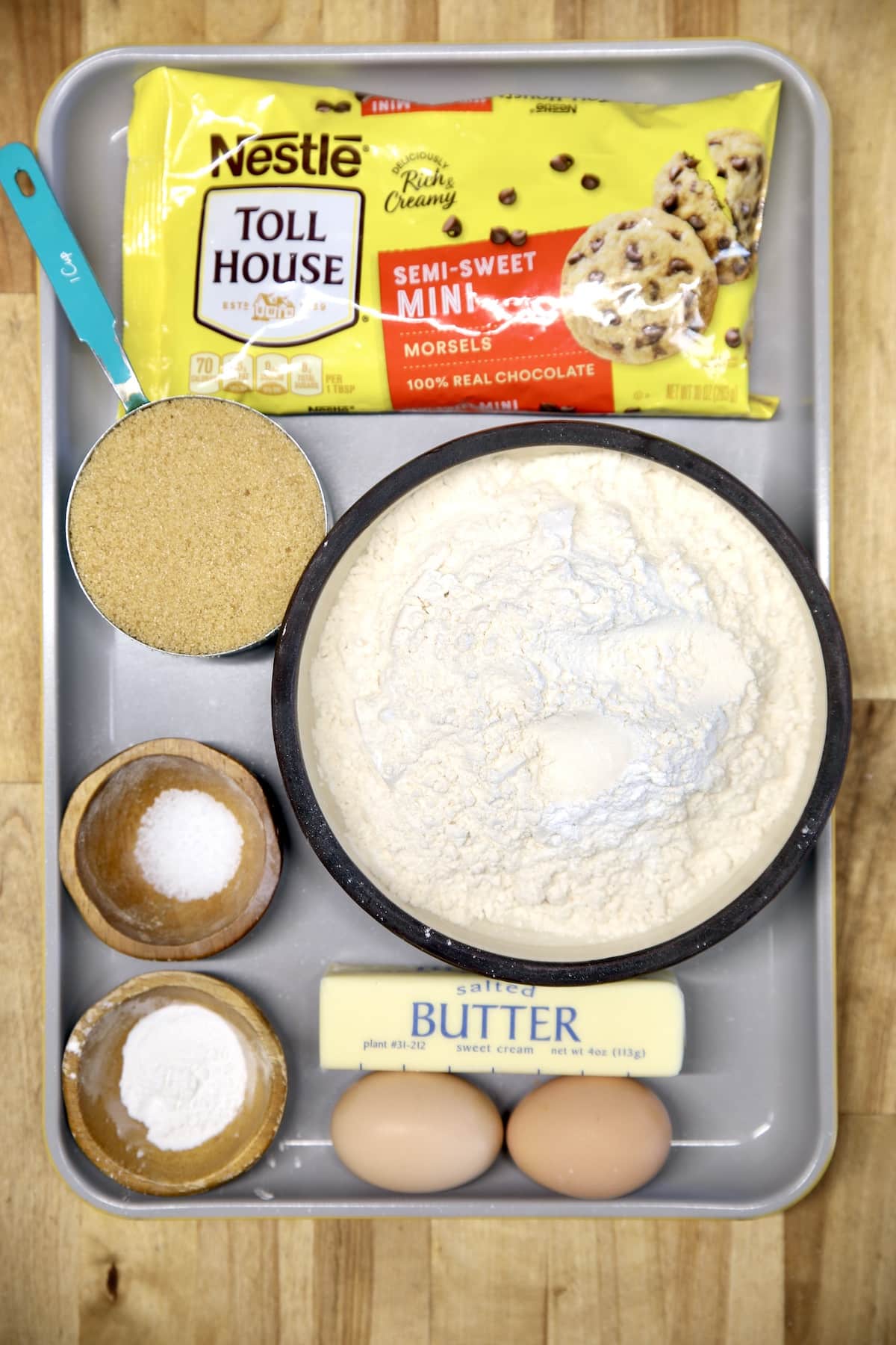 Sheet pan with ingredients for chocolate chip biscotti.