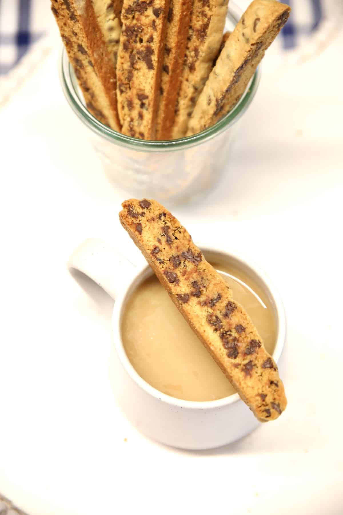 Chocolate chip biscotti on cup of coffee.