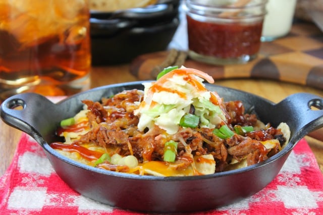 Brisket nachos with coleslaw in a cast iron skillet.