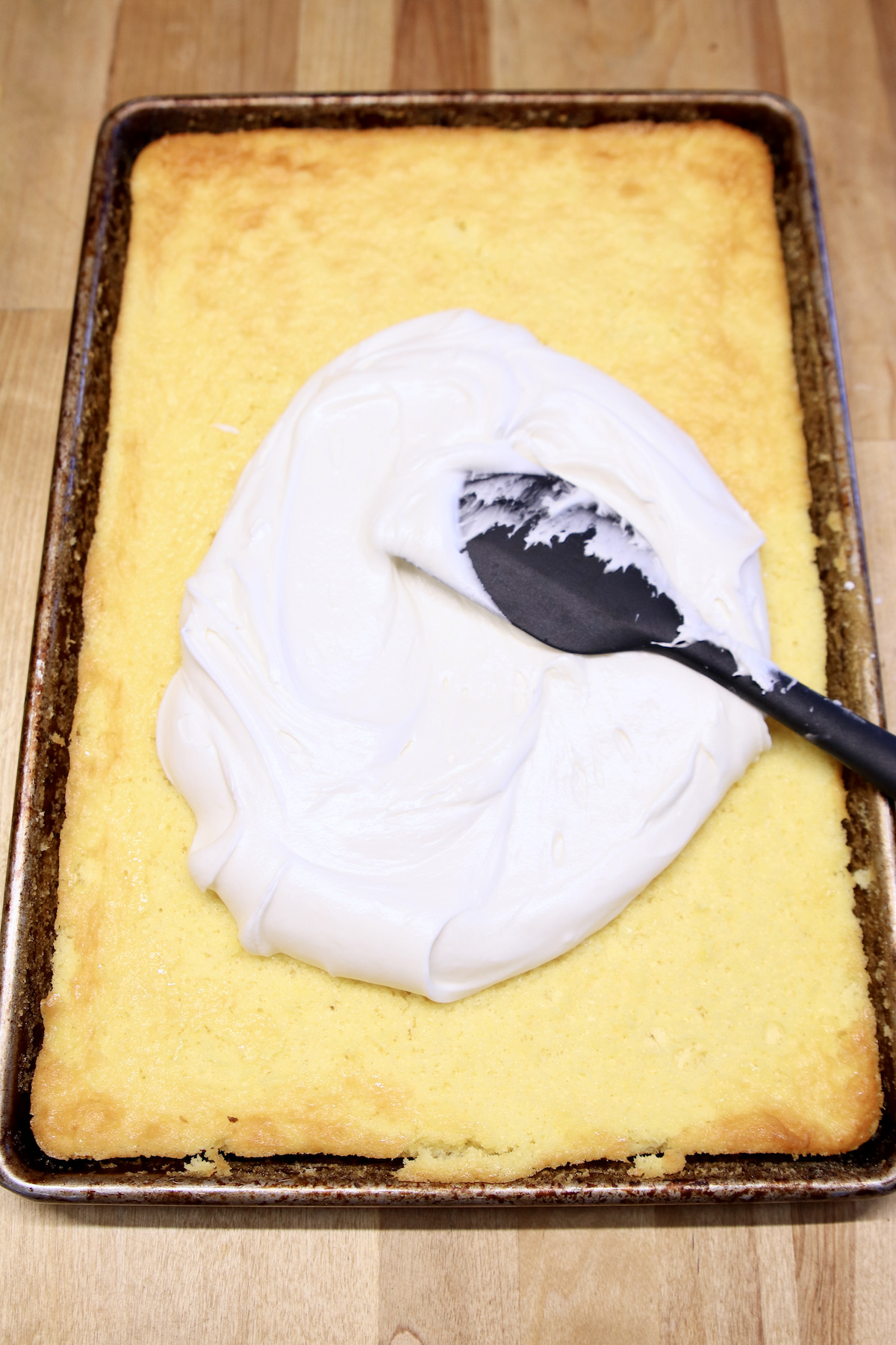 spreading icing over cake