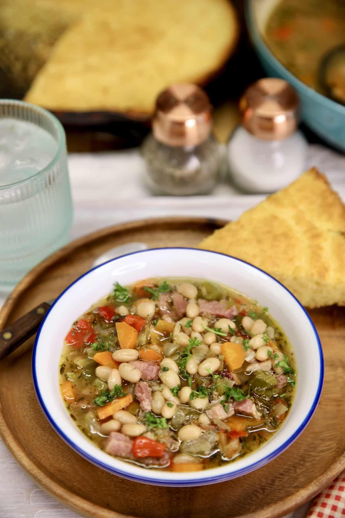 Ham and Bean Soup in a bowl, slice of cornbread. 