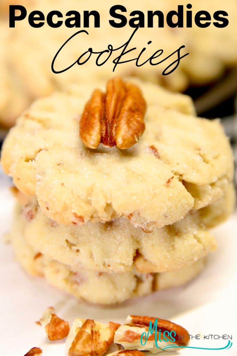 Pecan Sandies Cookies, stacked with pecan half on top - text overlay.