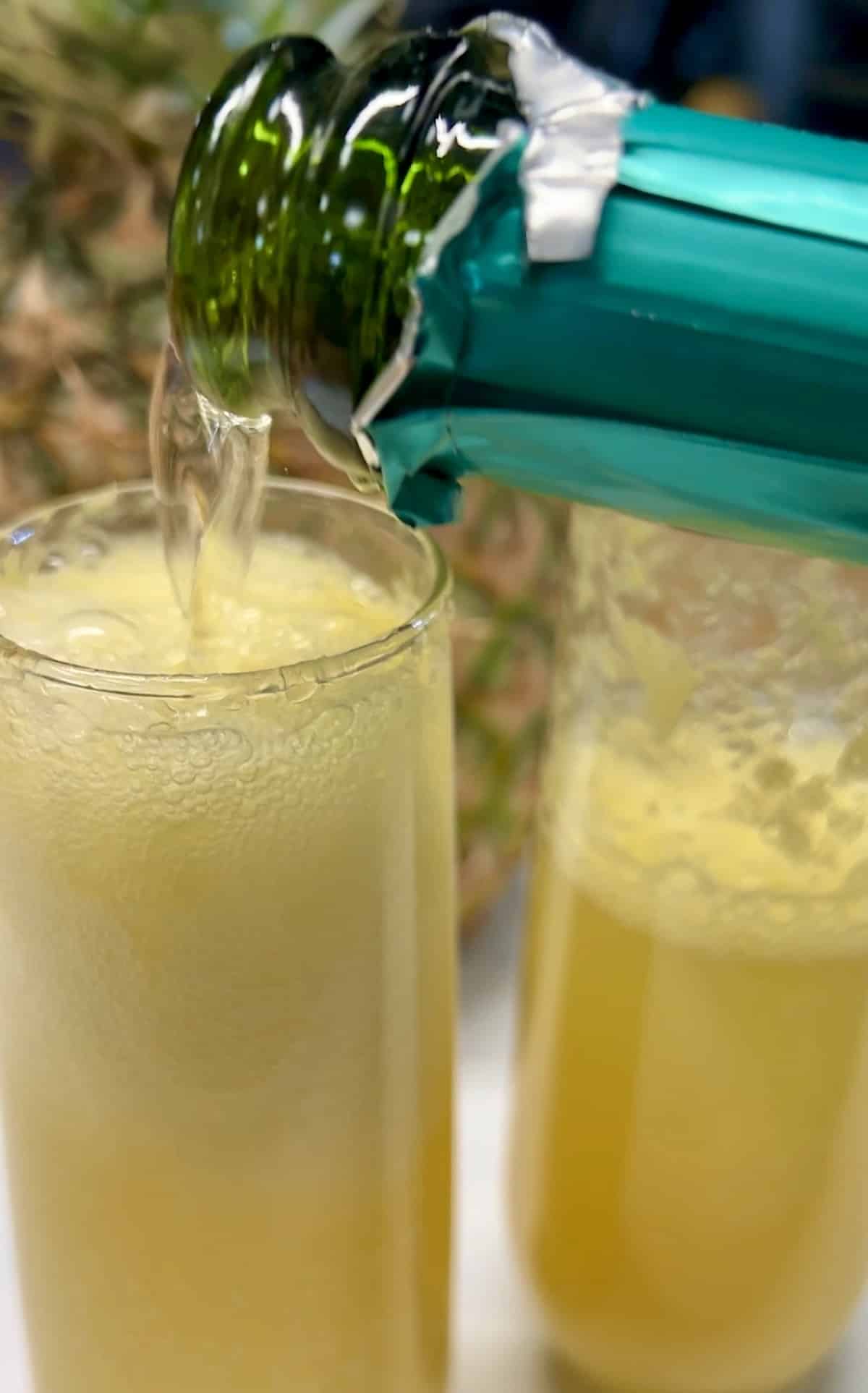 Filling champagne glasses with sparkling wine.