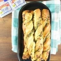 Cheesy Pesto Breadsticks are the perfect side for any meal. Packed with ooey gooey mozzarella cheese and tons of flavor from the sweet basil pesto. Made with Red Star Yeast. Recipe from missinthekitchen.com #ad