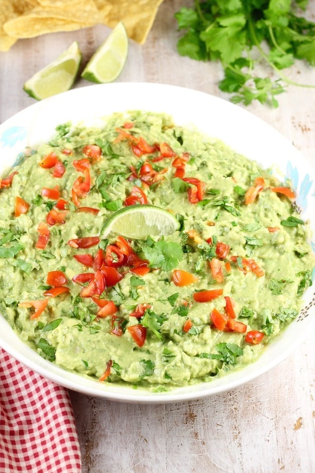 Roasted Garlic Guacamole is a delicious party appetizer or a must- have for taco night! From MissintheKitchen.com