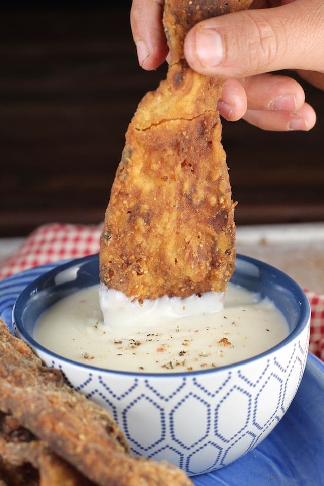 Chicken Fried Bacon dipped in gravy makes the most amazing breakfast or serve it as an appetizer! Recipe from MissintheKitchen.com