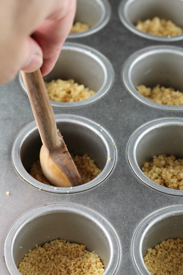 Adding crust for Mini Turtle Cheesecakes ~ MissintheKitchen.com