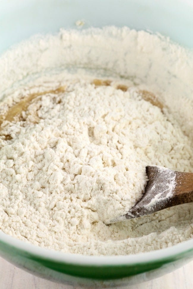 adding flour to the bowl for salted caramel cookie bars