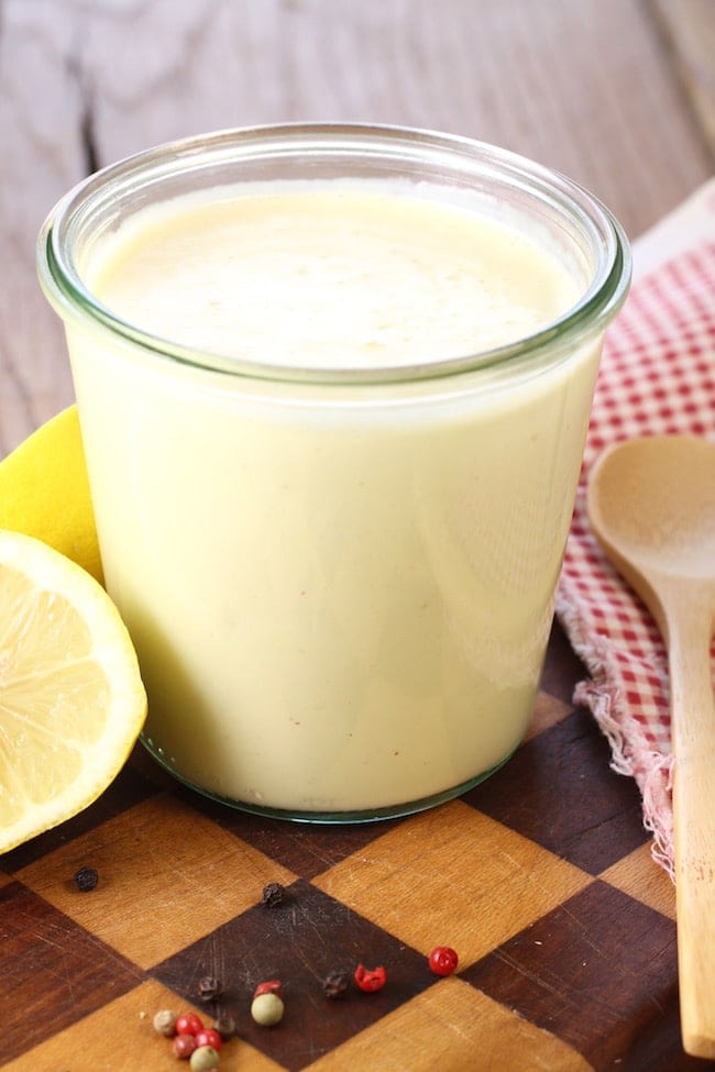 Creamy-Citrus-Salad-Dressing-in-jar-with-napkin-spoon-sliced-lemon