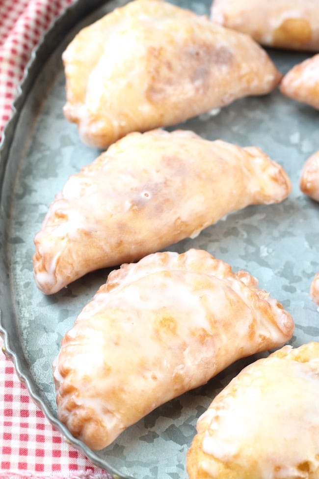 Fried Apple Hand Pies on a galvanized platter with red check napkin
